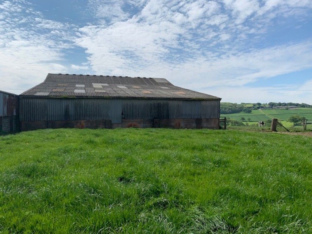 side view of barn in field